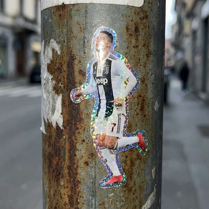 Holographic Cristiano Ronaldo Sticker on Urban Pole - Sports Action AI prompt