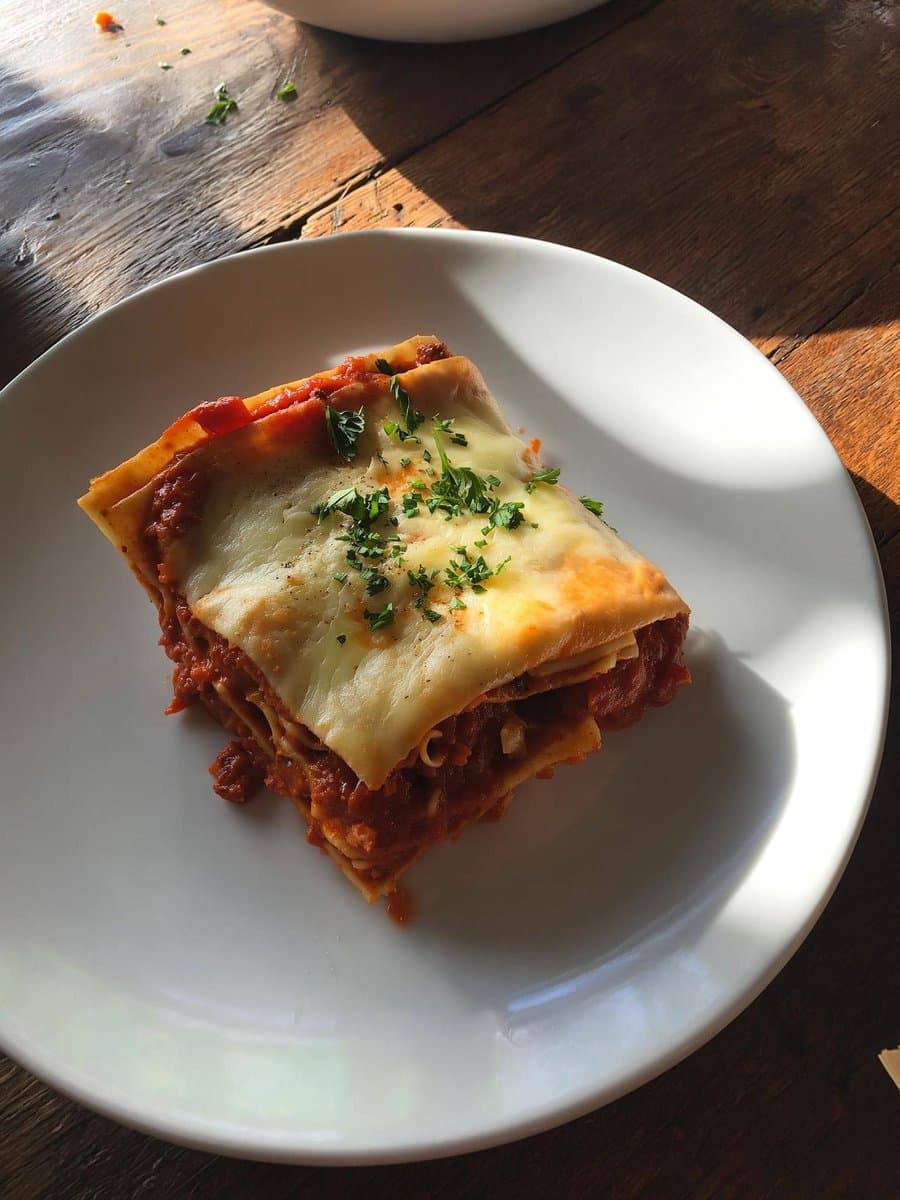 Delicious Lasagna Slice on White Plate - Food Photography - Food Culinary AI prompt